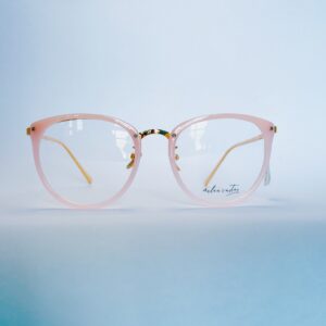 Stylish light pink round eyeglasses with subtle gold metallic detailing and clear lenses.