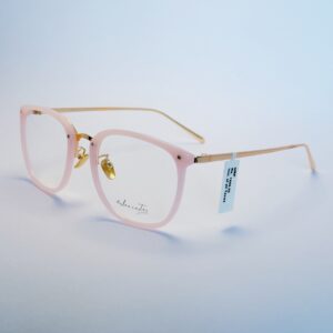 Stylish light pink round eyeglasses with subtle gold metallic detailing and clear lenses.