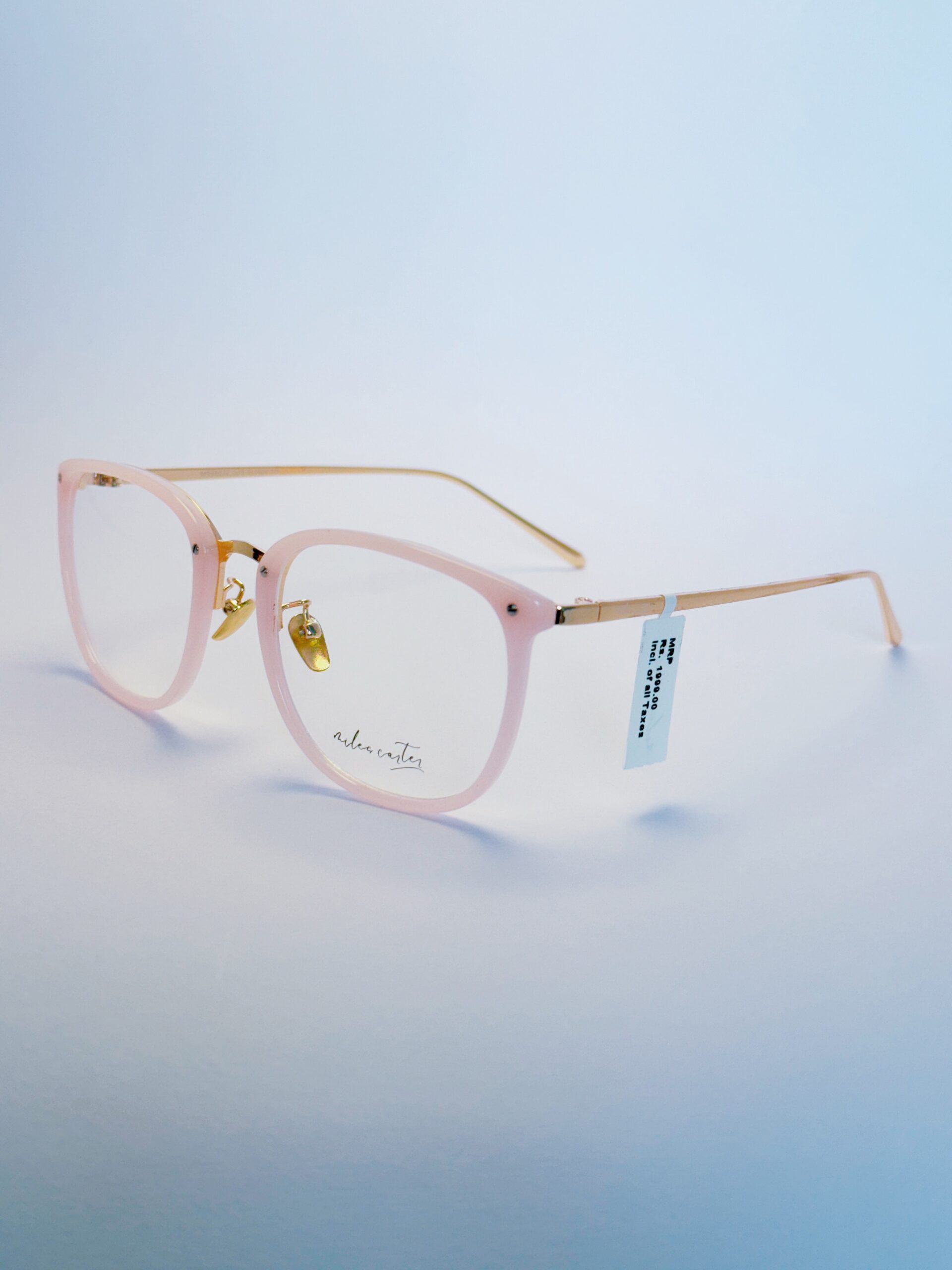 Trendy Light Pink Round Eyeglasses - SpexoVision Stylish light pink round eyeglasses with subtle gold metallic detailing and clear lenses.