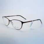 Close-up of stylish black round eyeglasses with subtle gold hardware.
