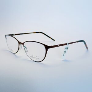 Close-up of stylish black round eyeglasses with subtle gold hardware.