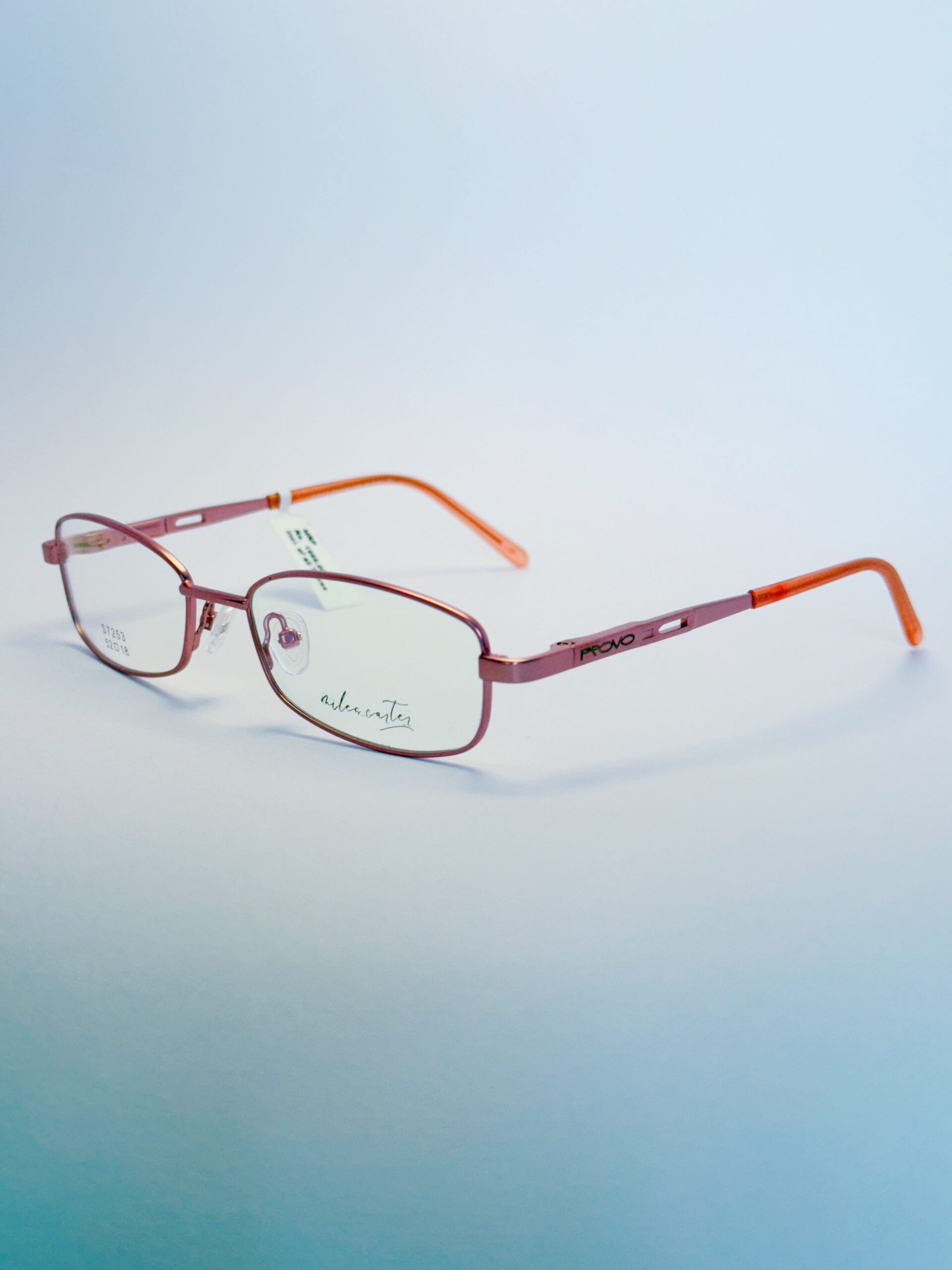 Pink Metal Rectangular Eyeglasses with Orange Temple Tips Stylish pink metal rectangular eyeglasses with orange temple tips, ideal for fashion and vision enhancement." . Available at website - www.spexovision.com