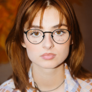 Close-up of stylish black round eyeglasses with subtle gold hardware.