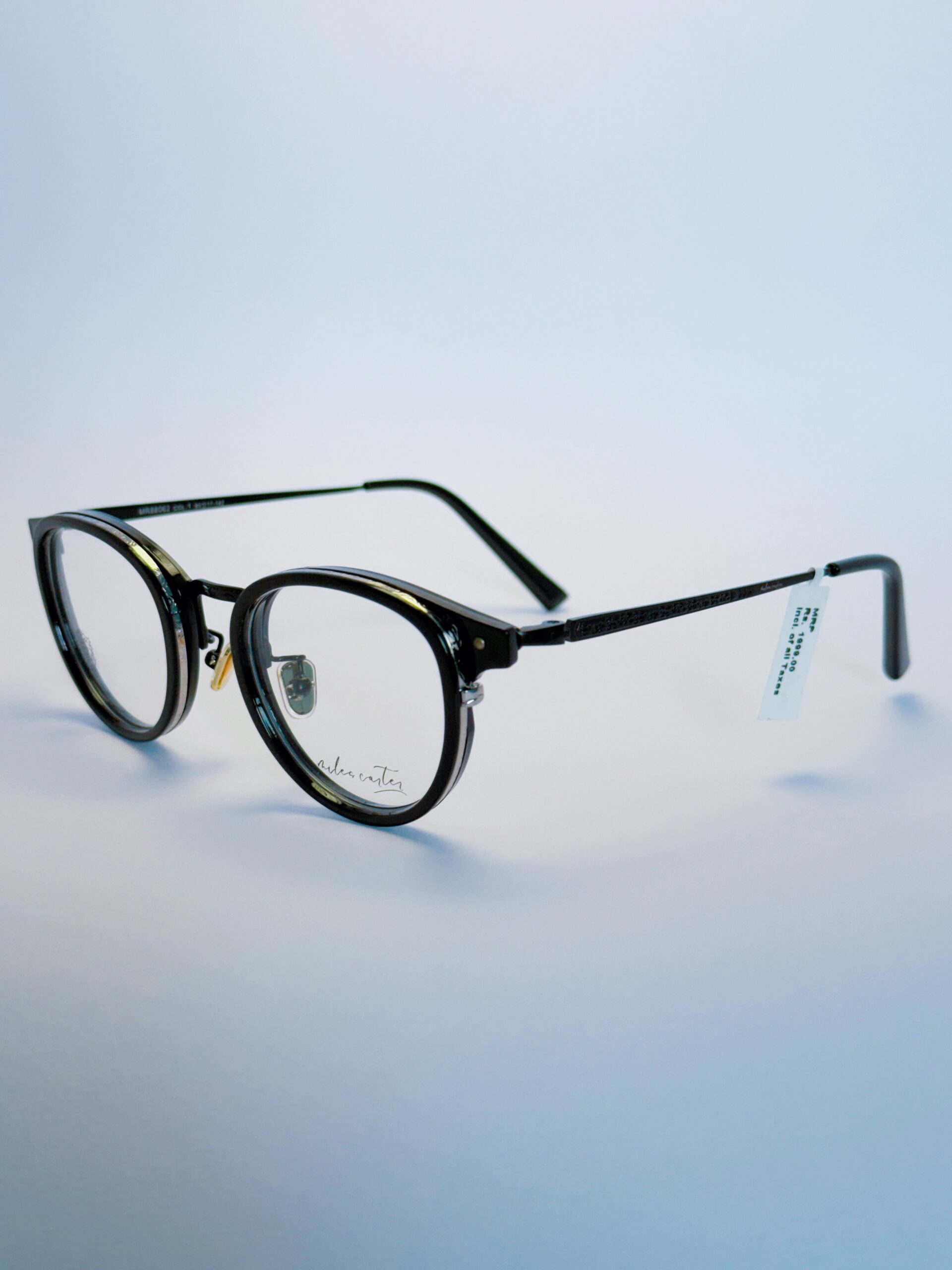 Black Round Metal Eyeglasses – Stylish and Trendy | Spexovision.com Black round eyeglasses with transparent lenses and metal bridge, displayed on a soft gradient background. Available at www.spexovision.com